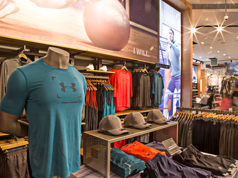 Interior photography featuring a mannequin elegantly styled with an Under Armour t-shirt. This image highlights the sporty and fashionable appeal of Under Armour apparel, with the mannequin serving as a stylish representation of the brand's clothing line. Ideal for retail brand promotions, fashion campaigns, and showcasing athletic wear, it emphasizes the quality and style of Under Armour products