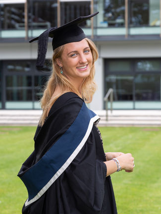 Portrait of an Oxford Brookes graduate dressed in cap and gown, set within the Oxford Brookes campus. This image celebrates academic achievement, capturing the pride and joy of graduation. The campus backdrop adds a sense of place and accomplishment, ideal for commemorating this significant milestone in educational and personal history