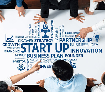 A diverse team collaborates on a startup business strategy, analyzing plans and ideas arou