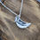 Thumbnail: silver bird necklace close up