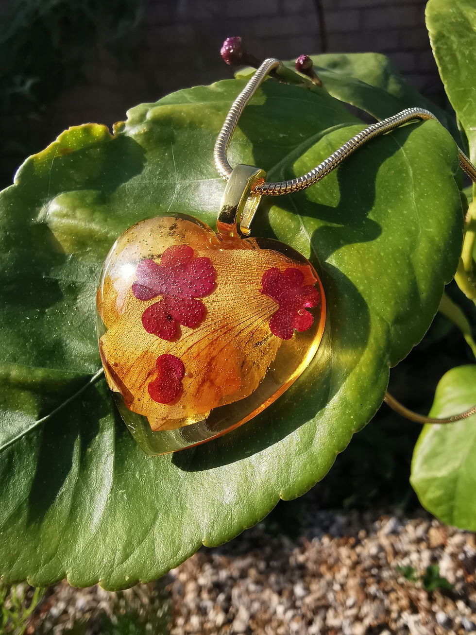 Yellow and red petal necklace on a leaf close up