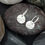 Thumbnail: silver hoop earrings on a pebble