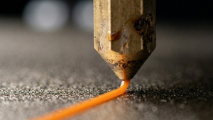 Zooming In on a Nozzle Laying Down a Layer of PETG