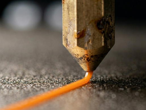 Zooming In on a Nozzle Laying Down a Layer of PETG
