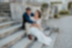 Wedding couple at their French wedding venue on the stairs