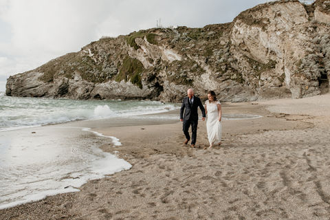 Bride and groom on lusty glaze beach