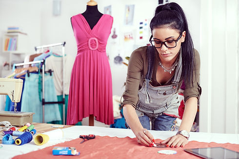 Woman Measuring Material in Studio