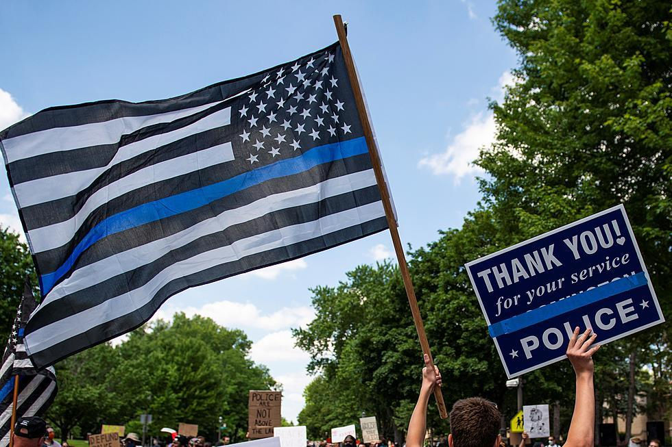 Thin blue line flag waving with a thank you for your service police sign