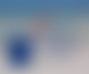 Brightly coloured bucket and spade on a beach with blog title:92 Bucket List Ideas to Make This Year a Year to Remember