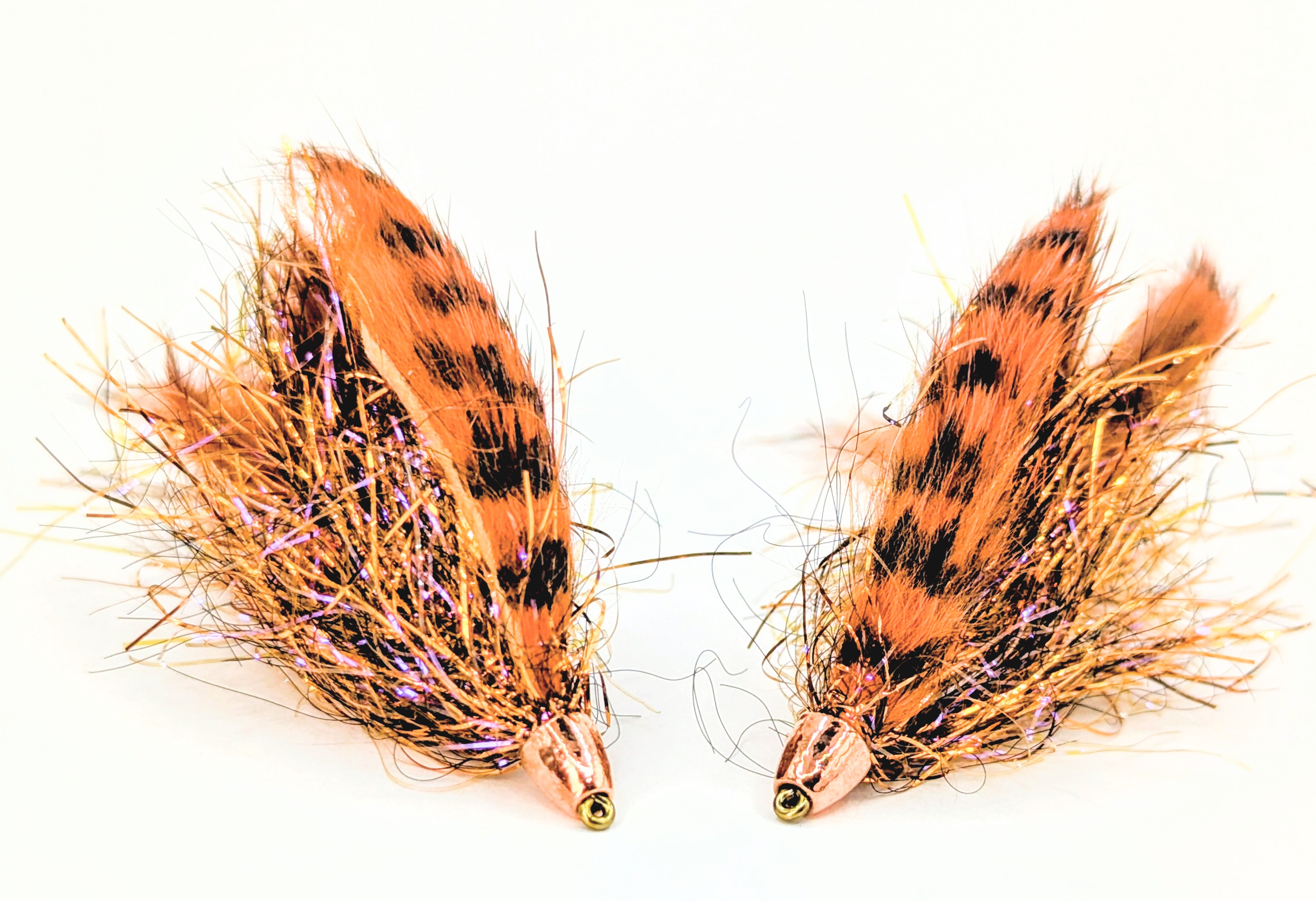 A muddler minnow fly with deer hair head.