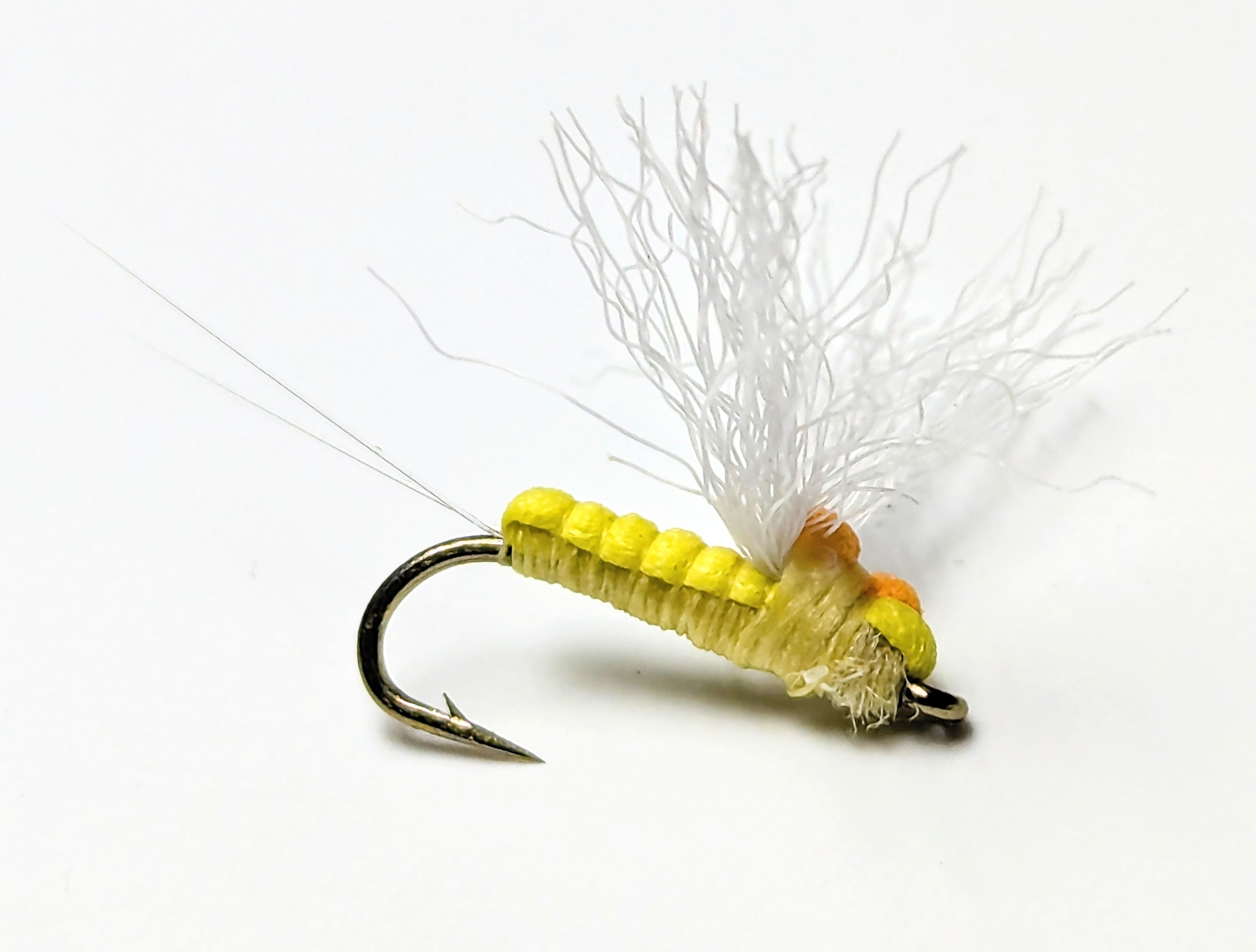 A detailed portrait of a handcrafted nymph fly.