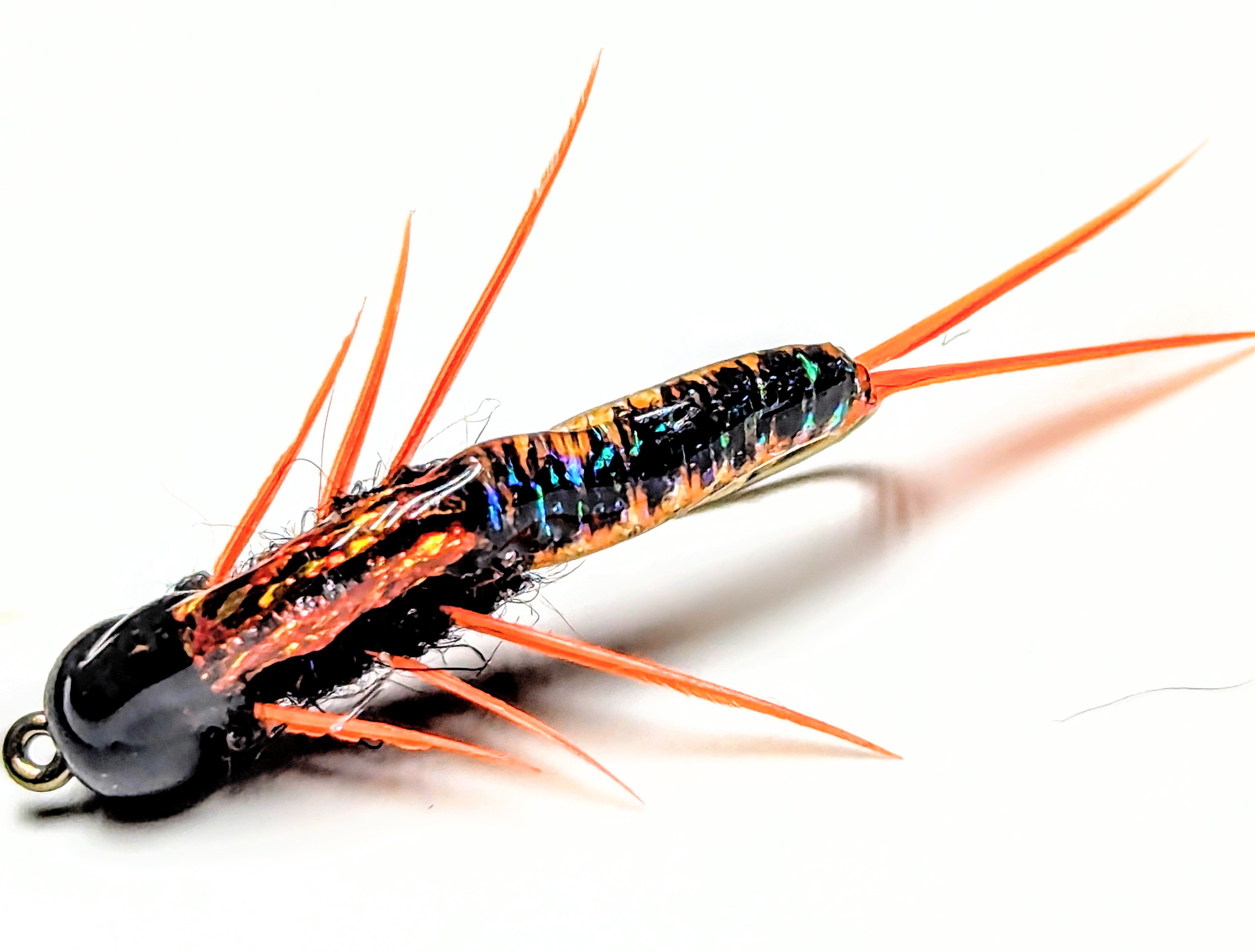 An olive woolly bugger streamer fly.