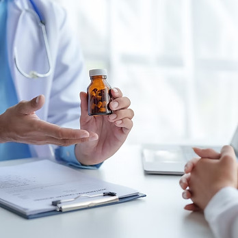 A care team member holding pills for treatment