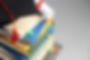 high-angle-stacked-books-graduation-cap-diploma-education-day.jpg