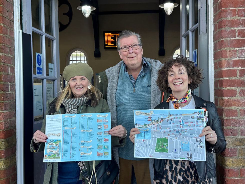 Three people showing maps for the Herne Bay community map launch.