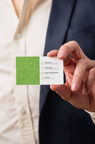 Person holding green business card design
