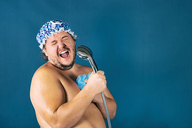 Funny fat man in blue cap sing in the shower. Fun and cleanliness.jpg