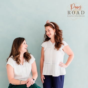 Two women in white tops smiling at each other; one seated, one standing. Light blue background with "Poppy Road Digital Strategies" text.
