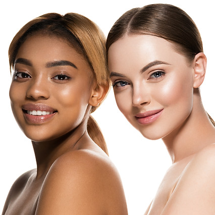 two women with heads side by side smiling