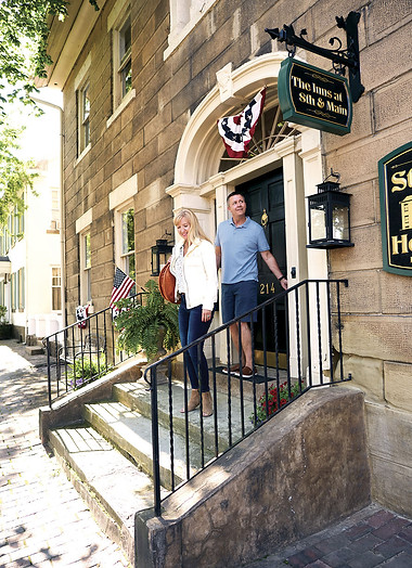 A couple leaving the Inns at 8th and Main and walking toward historic downtown.