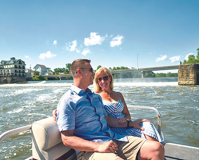 Couple boating on the Muskingum River with the historic Stockport Mill in the background in Morgan County, Ohio.