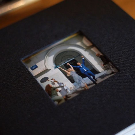 Black photo album with windowed cover and printed photo.