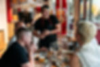 Chef Dan Shu with celebrating guest, beer and wine