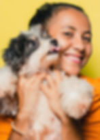 woman holding terrior yellow background