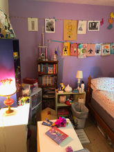 Very crowded small kids room with furniture and toys  leaving little floor space. 
