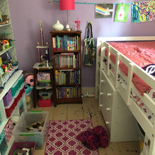 A long shot of the finished bedroom. A dresser facing out from under the loft bed. 