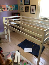 A loft bed in the middle stages of construction. 