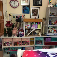 The completed room from the side facing the bed: Lower shelved with a lamp, dollhouse, and another shelviing unit on top of them. 