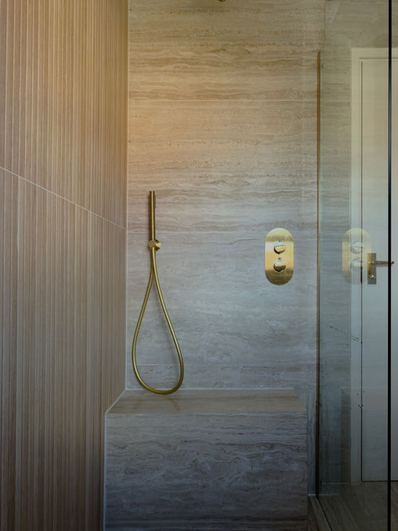 Wall-hung WC with concealed cistern and warm stone finish