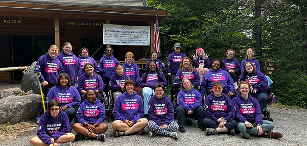 A group of disabled people in purple sweatshirts that say "Disabled Women Make History"