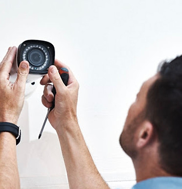 Man fixing an outdoor cctv camera