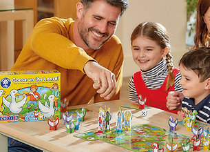 A father, mother and two kids playing orchard toys games