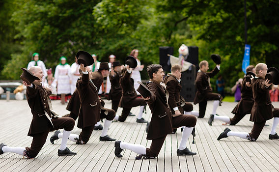 Folk dancers in Hiiumaa costume perform outdoors