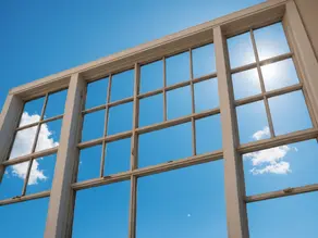 Large, clean glass windows reflecting a bright blue sky with scattered clouds. Sunlight shines through the panes, emphasizing the clarity and streak-free finish.