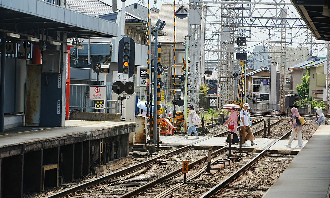 A group of people walking on a train tra