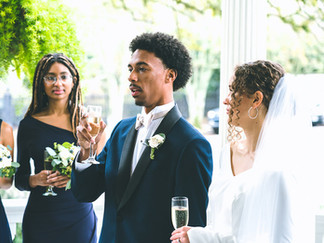 Wedding videography still of newlyweds giving a toast on the porch at The Sully Mansion in New Orleans