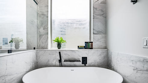 Bright residential bathroom with vanity, mirror, and modern fixtures