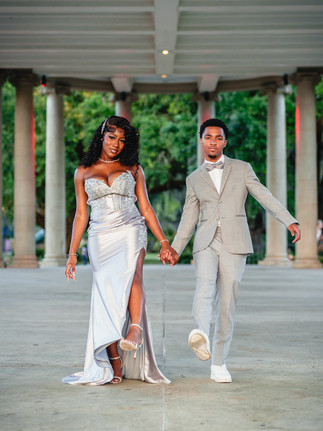 Best friends posing under City Park Peristyle during Edna Karr prom portraits