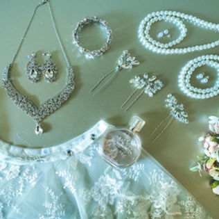 Ramonica’s wedding invitation, rings and bridal accessories arranged in a flatlay before her Treme Market Branch wedding