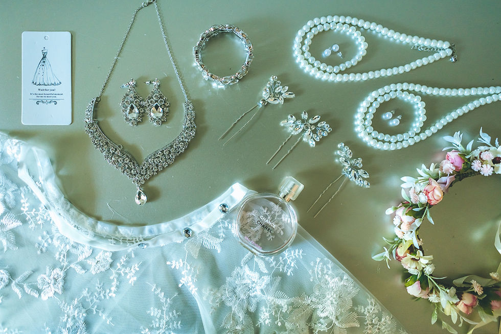 Ramonica’s wedding invitation, rings and bridal accessories arranged in a flatlay before her Treme Market Branch wedding