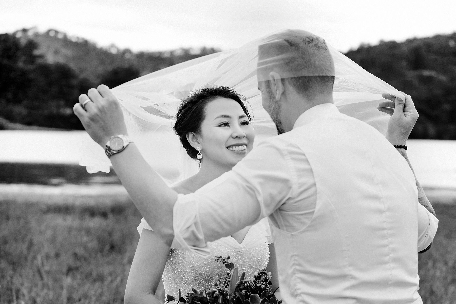 Wedding couple veil shot pose