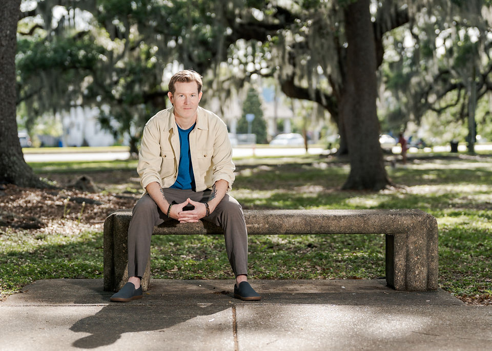Professional branding image of an entrepreneur standing near a path in City Park New Orleans