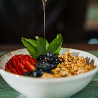 honey poured over a parfait bowl
