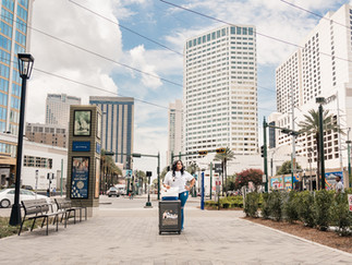 Travel advisor Regina Moore photographed near New Orleans landmarks at the end of Canal Street.