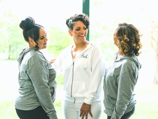Bride laughing with bridesmaids while getting ready for a New Orleans wedding
