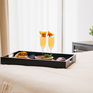 champagne and orange juice on a hotl room bed